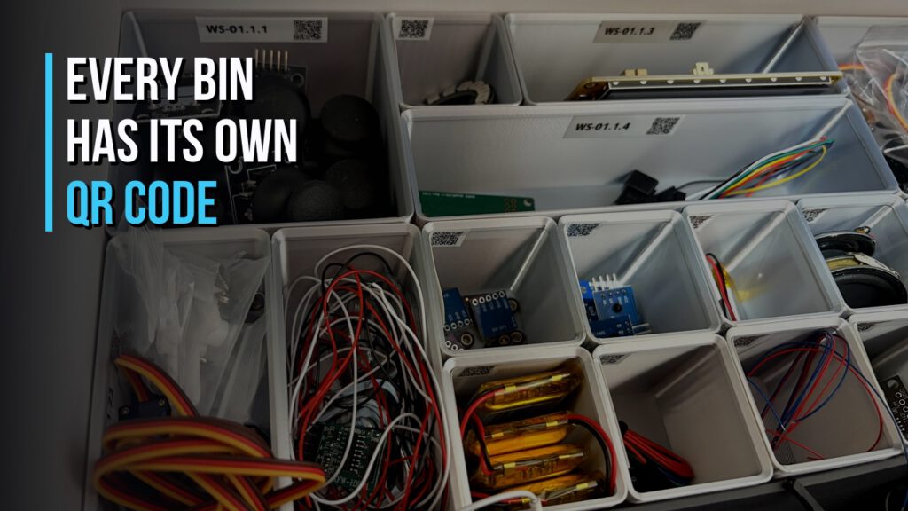 Drawer with 3D printed Gridfinity bins, each bin labelled with its own QR code, holding sorted electronic components