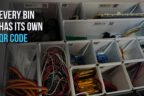 Drawer with 3D printed Gridfinity bins, each bin labelled with its own QR code, holding sorted electronic components